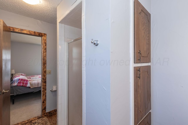 bathroom with ensuite bath, a textured ceiling, and a stall shower