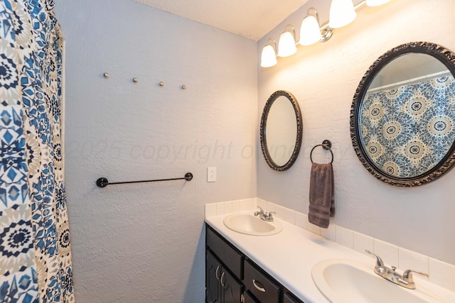 full bathroom with a shower with curtain, double vanity, and a sink