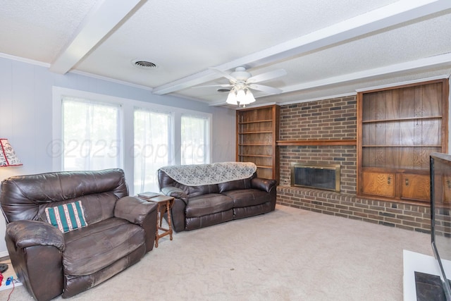 carpeted living room with a textured ceiling, visible vents, beamed ceiling, a ceiling fan, and a fireplace