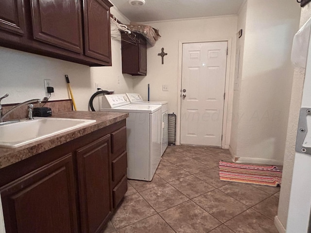 laundry area featuring independent washer and dryer, cabinets, sink, and light tile patterned flooring