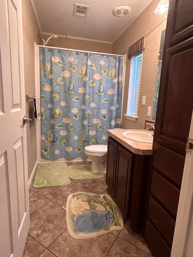 bathroom with ornamental molding, tile patterned flooring, a textured ceiling, and toilet