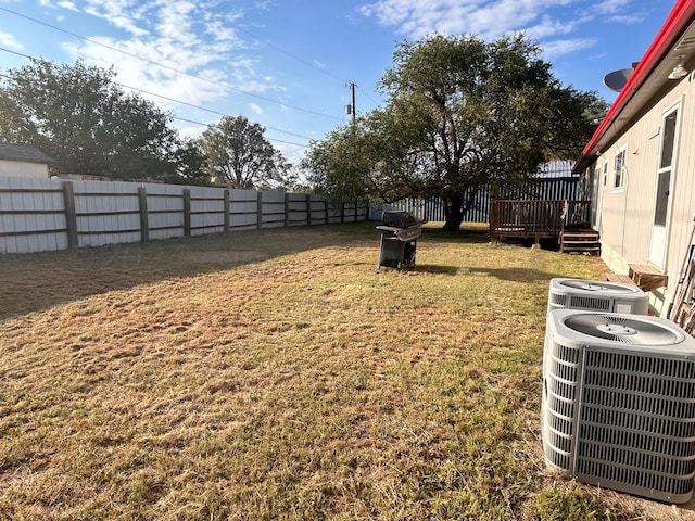 view of yard featuring central air condition unit