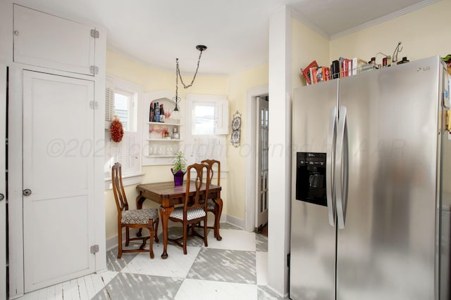 2402 S Ong St, Amarillo, TX 79109 - kitchen with stainless steel fridge, crown molding, and hanging light fixtures