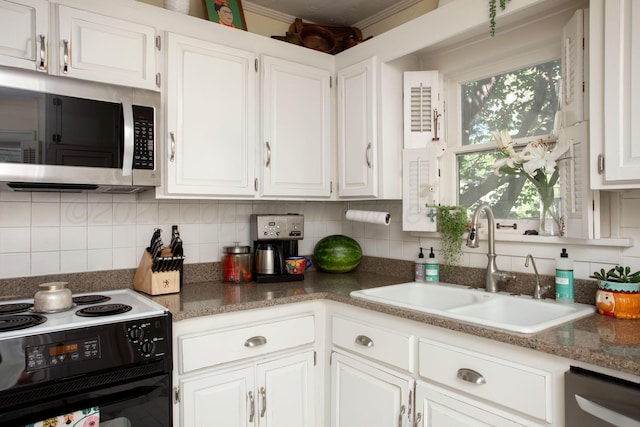 2402 S Ong St, Amarillo, TX 79109 - kitchen with stainless steel appliances, white cabinetry, backsplash, and ornamental molding