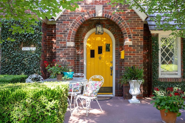2402 S Ong St, Amarillo, TX 79109 - doorway to property featuring brick siding and a patio area