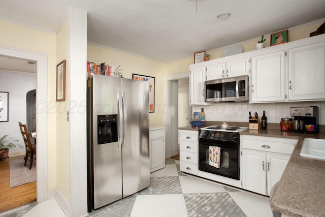2402 S Ong St, Amarillo, TX 79109 - kitchen featuring stainless steel appliances, tasteful backsplash, white cabinetry, and ornamental molding