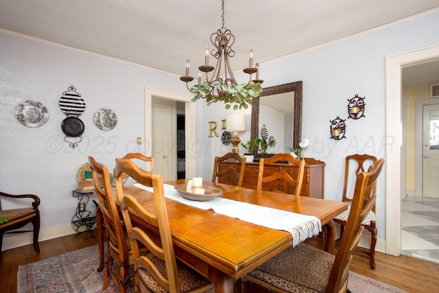 2402 S Ong St, Amarillo, TX 79109 - dining area featuring a chandelier, crown molding, and wood finished floors