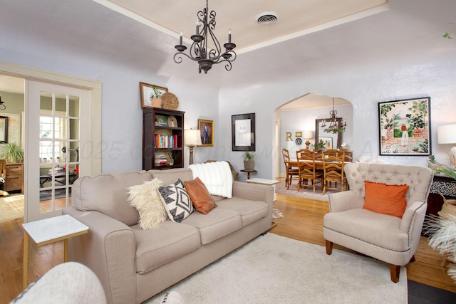 2402 S Ong St, Amarillo, TX 79109 - living area featuring a chandelier, arched walkways, and wood finished floors