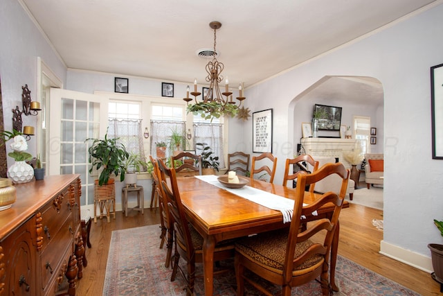 2402 S Ong St, Amarillo, TX 79109 - dining room with arched walkways, wood finished floors, and ornamental molding