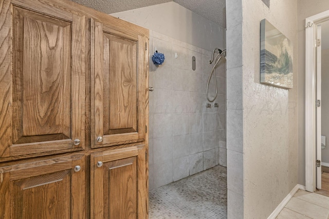 1607 N Mary-Ellen St, Pampa, TX 79065 - full bath featuring a walk in shower, a textured wall, a textured ceiling, and tile patterned flooring