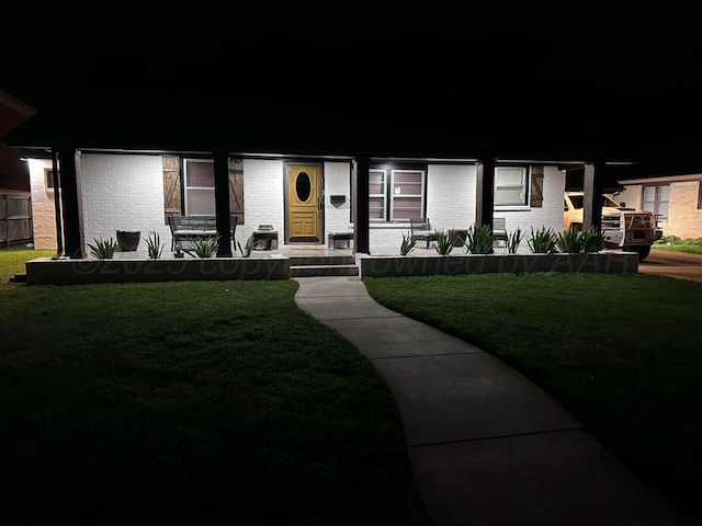 1607 N Mary-Ellen St, Pampa, TX 79065 - view of front facade with brick siding and a yard