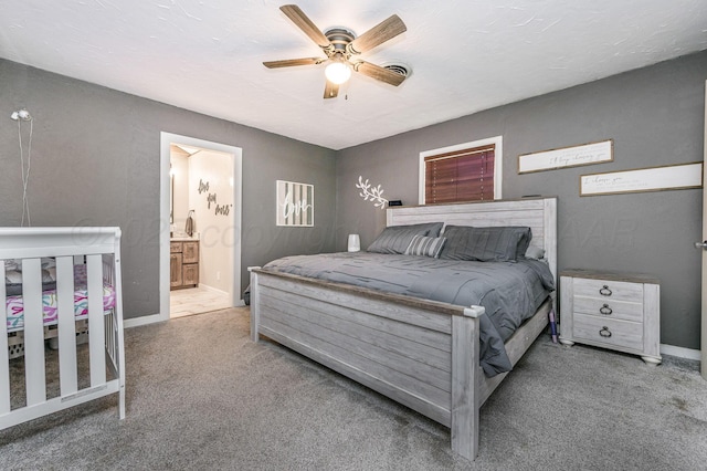 1607 N Mary-Ellen St, Pampa, TX 79065 - carpeted bedroom with baseboards, a ceiling fan, and connected bathroom