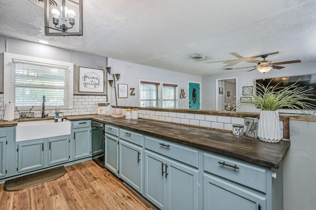 1607 N Mary-Ellen St, Pampa, TX 79065 - kitchen featuring wood counters, a sink, dishwasher, light wood finished floors, and tasteful backsplash