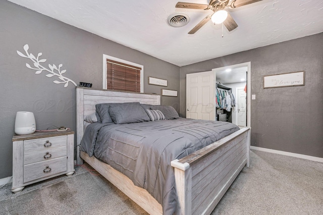 1607 N Mary-Ellen St, Pampa, TX 79065 - bedroom featuring light carpet, a spacious closet, baseboards, a ceiling fan, and a closet