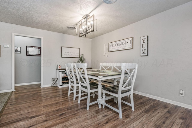 1607 N Mary-Ellen St, Pampa, TX 79065 - dining area featuring a chandelier, a textured ceiling, wood finished floors, and baseboards
