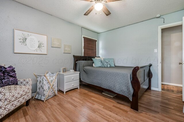 1607 N Mary-Ellen St, Pampa, TX 79065 - bedroom with light wood-type flooring, a textured ceiling, and a ceiling fan