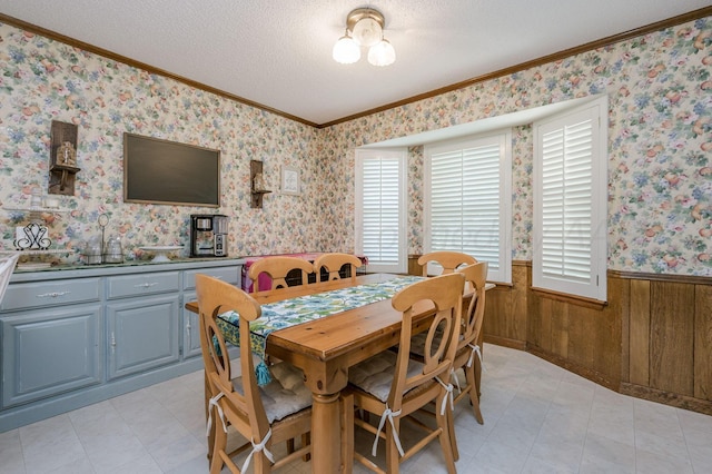 314 Fir St, Hereford, TX 79045 - dining room with wainscoting, ornamental molding, a textured ceiling, wooden walls, and wallpapered walls
