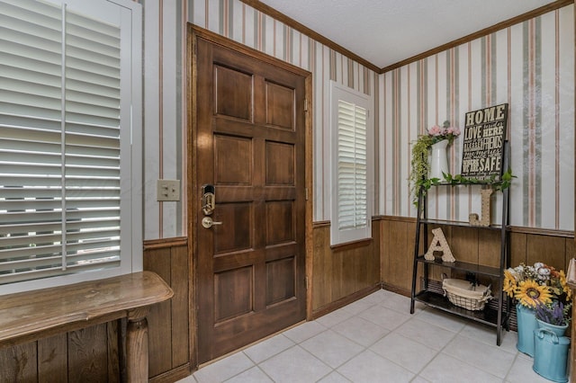 314 Fir St, Hereford, TX 79045 - entrance foyer with crown molding, wainscoting, light tile patterned flooring, wallpapered walls, and healthy amount of natural light