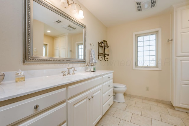 314 Fir St, Hereford, TX 79045 - bathroom featuring vanity, toilet, tile patterned floors, and baseboards