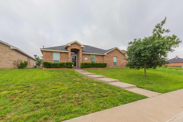 ranch-style home with a front yard and central air condition unit