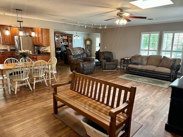 112 Houston St, Borger, TX 79007 - living area with ceiling fan, ornamental molding, a skylight, and wood finished floors