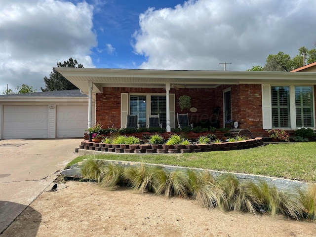 112 Houston St, Borger, TX 79007 - ranch-style house featuring brick siding, driveway, a garage, and a front lawn