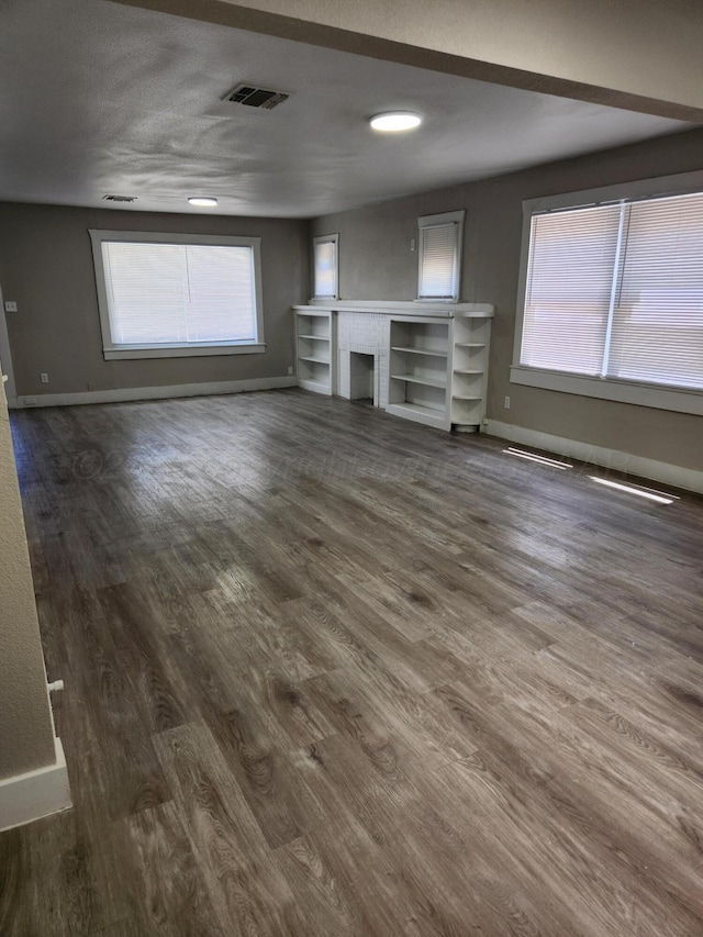 904 S Mississippi St, Amarillo, TX 79106 - unfurnished living room with baseboards and dark wood-style floors