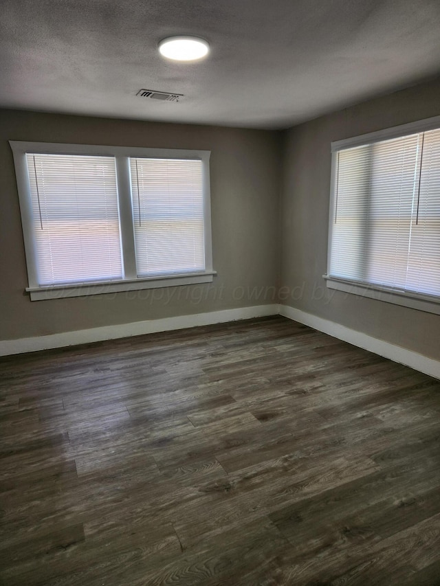904 S Mississippi St, Amarillo, TX 79106 - spare room with baseboards, healthy amount of natural light, and dark wood-style floors
