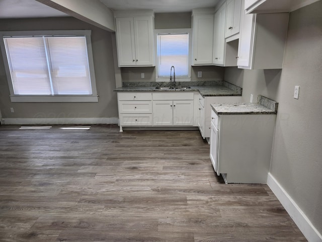 904 S Mississippi St, Amarillo, TX 79106 - kitchen with a sink, white cabinets, baseboards, and dark stone countertops