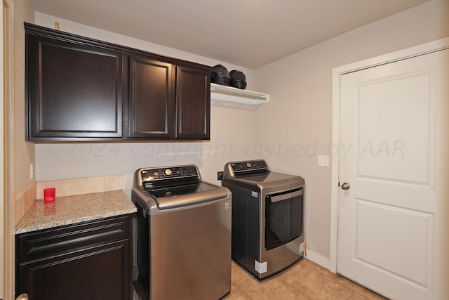 9709 Sydney Dr, Amarillo, TX 79119 - washroom with cabinet space, light tile patterned floors, and independent washer and dryer