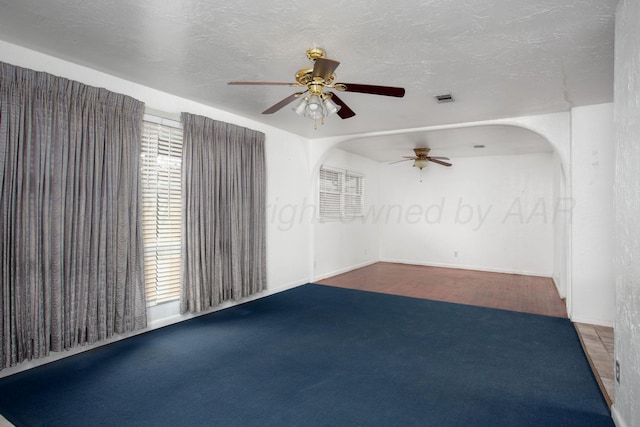 2501 S Bivins St, Amarillo, TX 79103 - empty room featuring a ceiling fan, carpet, and arched walkways