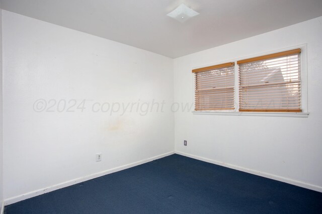 2501 S Bivins St, Amarillo, TX 79103 - empty room featuring dark colored carpet and baseboards
