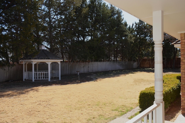 view of yard featuring fence and a gazebo