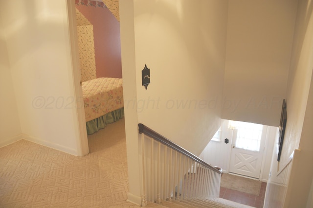 staircase with carpet floors and baseboards