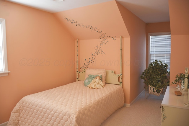 bedroom with light carpet, baseboards, and lofted ceiling