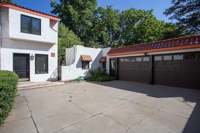 2615 S Hayden St, Amarillo, TX 79109 - mediterranean / spanish-style home featuring driveway, a tile roof, and an attached garage