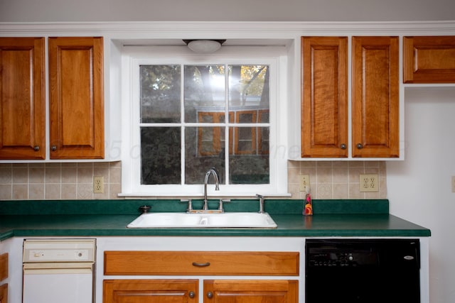 2615 S Hayden St, Amarillo, TX 79109 - kitchen with black dishwasher, dark countertops, backsplash, and brown cabinetry