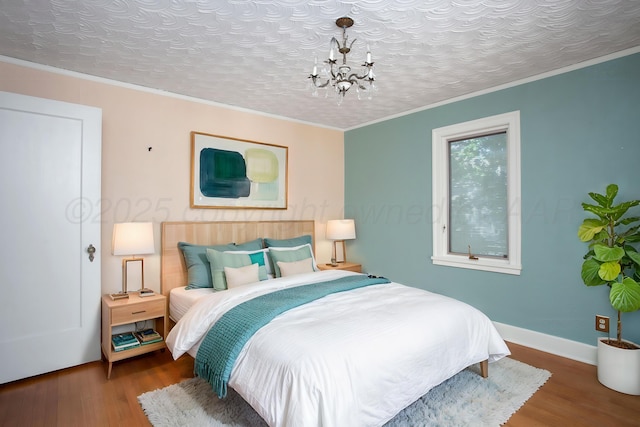 2615 S Hayden St, Amarillo, TX 79109 - bedroom featuring wood finished floors, a chandelier, and ornamental molding