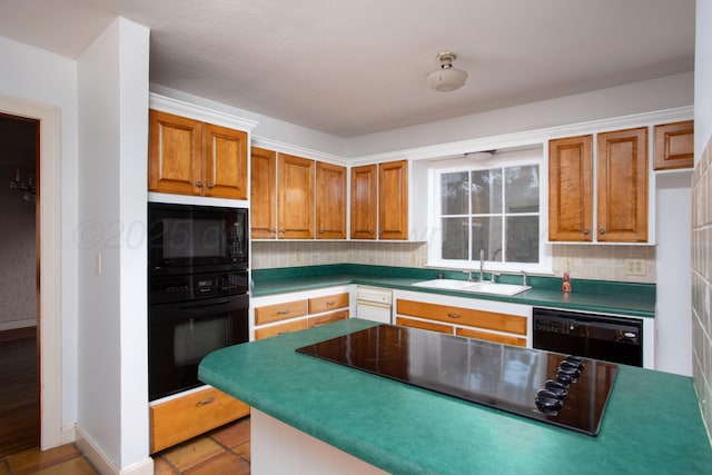 2615 S Hayden St, Amarillo, TX 79109 - kitchen featuring black appliances, tasteful backsplash, and brown cabinets