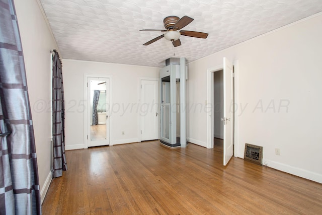 2615 S Hayden St, Amarillo, TX 79109 - unfurnished bedroom featuring wood finished floors, crown molding, and a ceiling fan