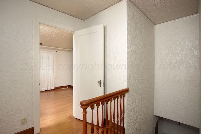 2615 S Hayden St, Amarillo, TX 79109 - staircase featuring wood finished floors, a textured ceiling, a textured wall, and crown molding