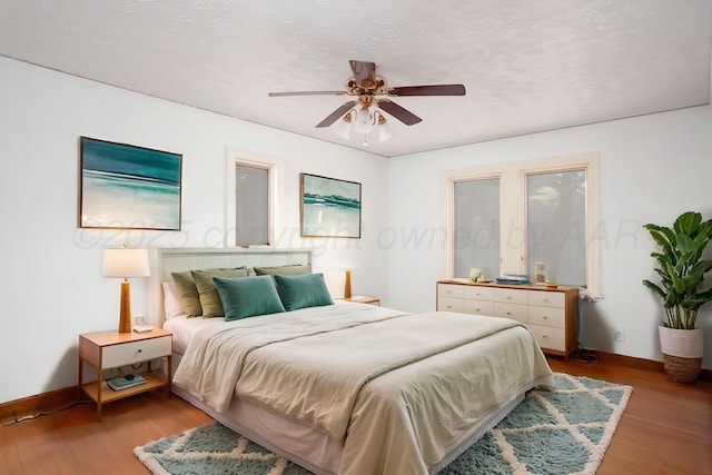 2615 S Hayden St, Amarillo, TX 79109 - bedroom with wood finished floors, ceiling fan, and a textured ceiling