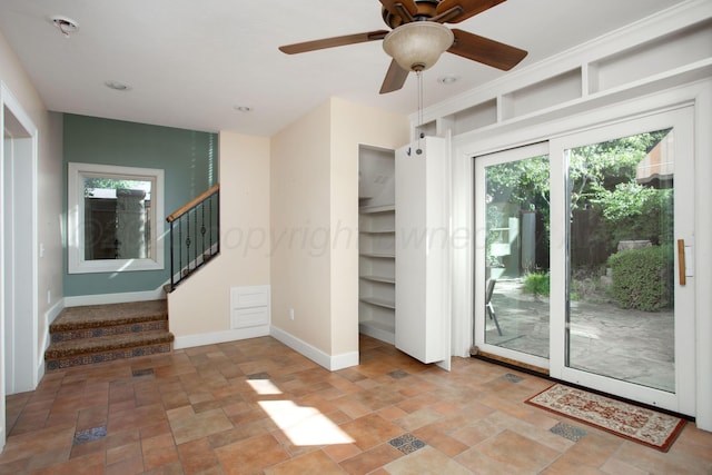 2615 S Hayden St, Amarillo, TX 79109 - spare room with stone finish floors, healthy amount of natural light, stairway, and a ceiling fan