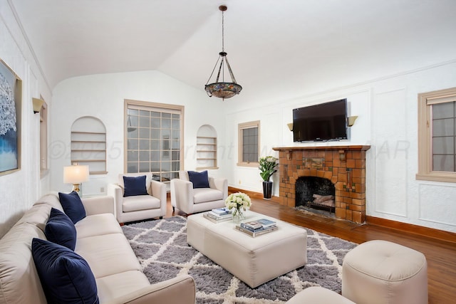 2615 S Hayden St, Amarillo, TX 79109 - living room featuring built in features, wood finished floors, vaulted ceiling, and a fireplace