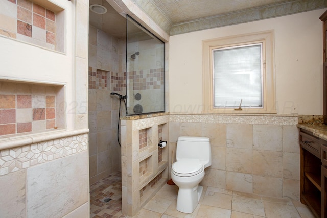 2615 S Hayden St, Amarillo, TX 79109 - bathroom featuring tile walls, vanity, a walk in shower, and wainscoting