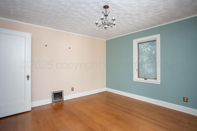 2615 S Hayden St, Amarillo, TX 79109 - empty room with a chandelier, wood finished floors, and ornamental molding