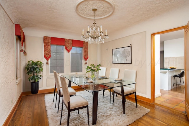2615 S Hayden St, Amarillo, TX 79109 - dining space featuring a chandelier, a textured ceiling, and wood finished floors