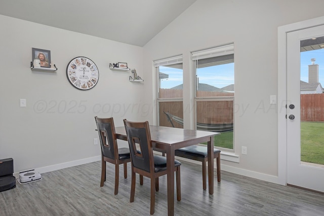 1801 Callaway Pl, Amarillo, TX 79118 - dining area featuring wood finished floors, vaulted ceiling, plenty of natural light, and baseboards
