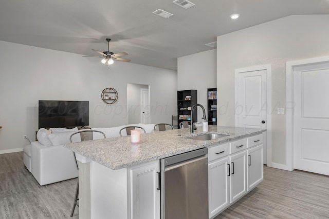 1801 Callaway Pl, Amarillo, TX 79118 - kitchen with dishwasher, a sink, a ceiling fan, open floor plan, and a kitchen bar