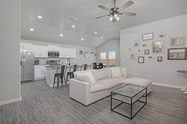 1801 Callaway Pl, Amarillo, TX 79118 - living room featuring lofted ceiling, wood finished floors, ceiling fan, baseboards, and recessed lighting